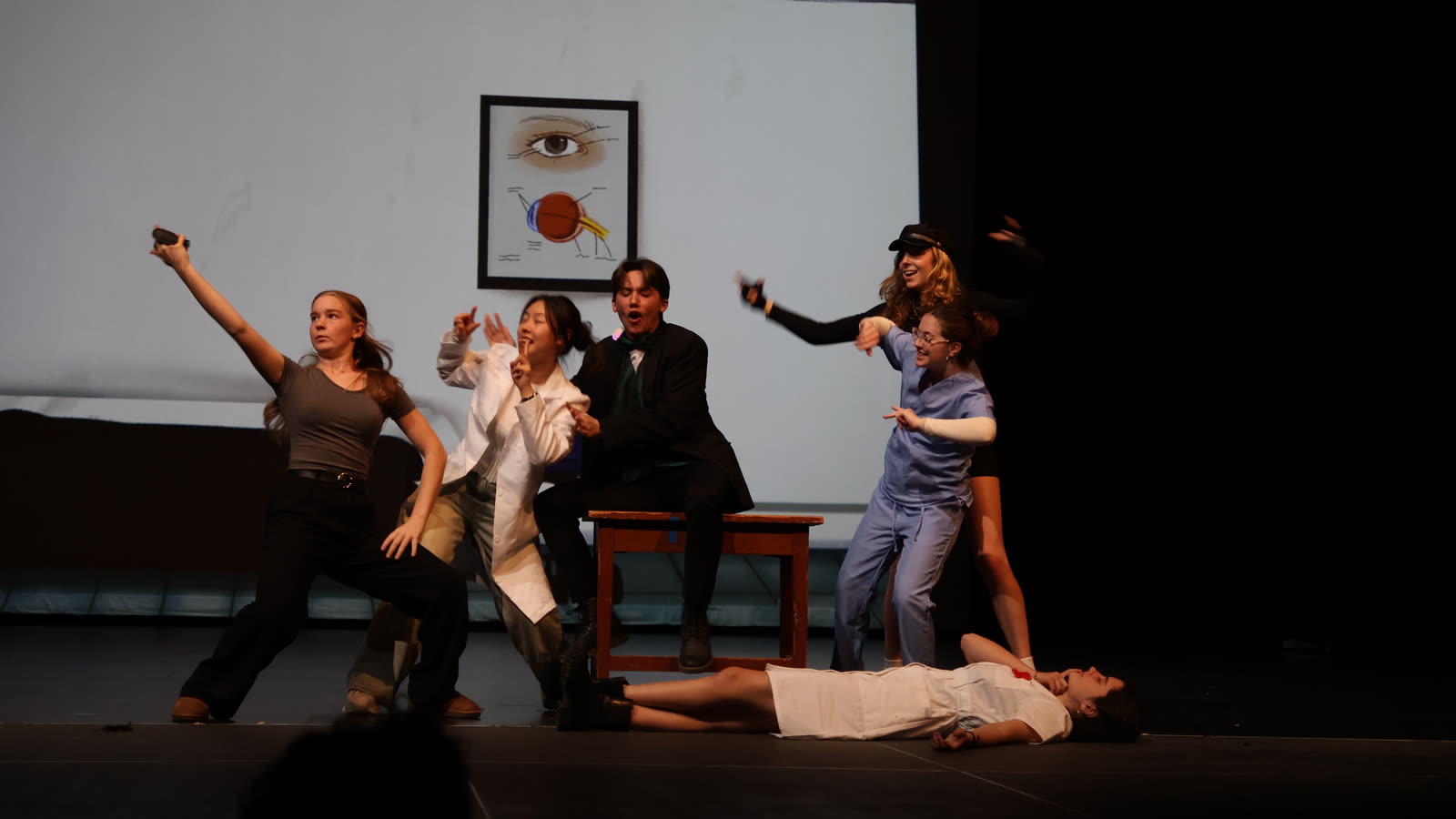 Drama students mid-scene in a comedy performance